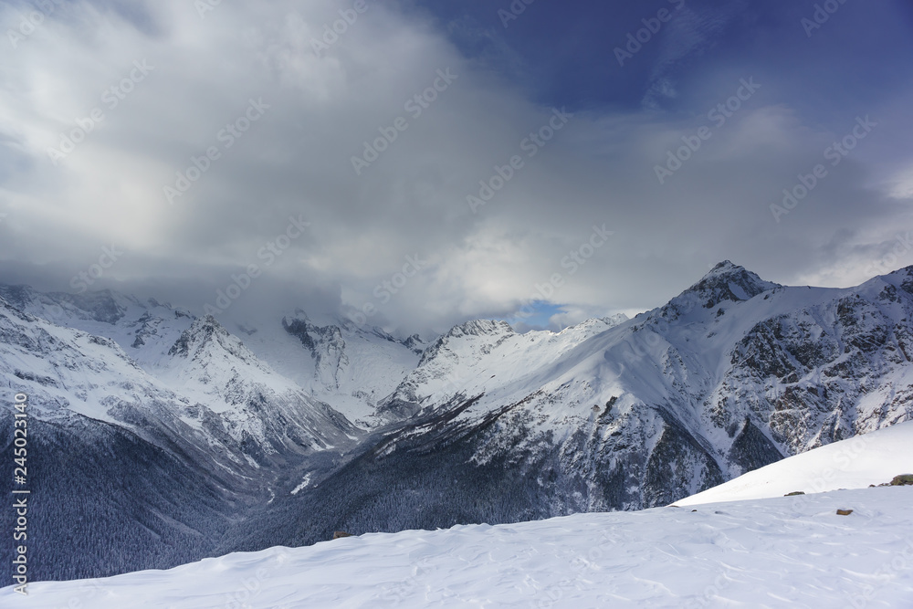Snow cloud covered the top of the main Caucasian ridge near the resort ski village Dombay