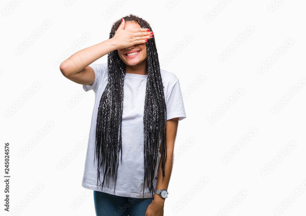 Young braided hair african american girl over isolated background smiling and laughing with hand on face covering eyes for surprise. Blind concept. Young braided hair african american girl over isolated background smiling and laughing with hand on face covering eyes for surprise. Blind concept.
