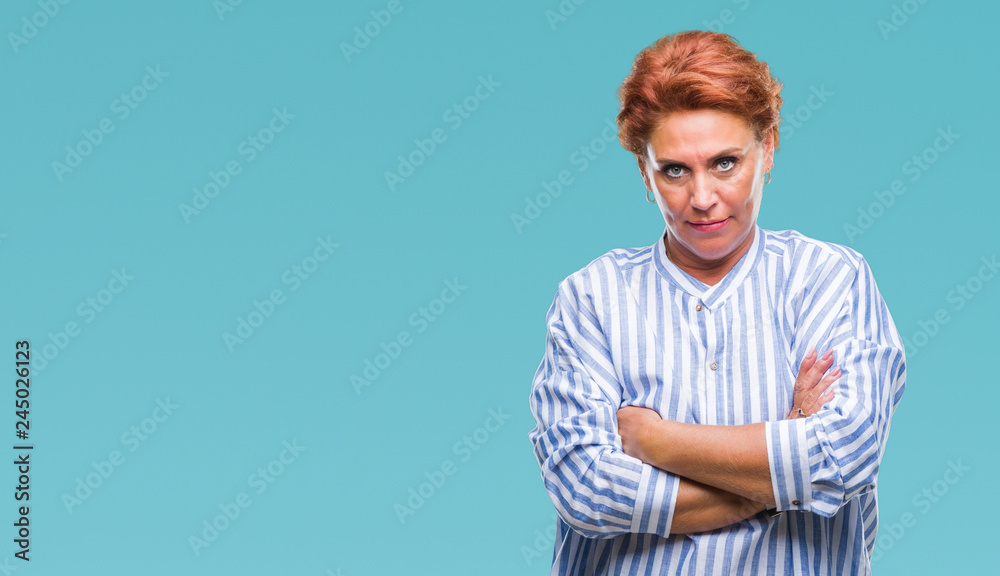 Atrractive senior caucasian redhead woman over isolated background skeptic and nervous, disapproving expression on face with crossed arms. Negative person. Atrractive senior caucasian redhead woman over isolated background skeptic and nervous, disapproving expression on face with crossed arms. Negative person.