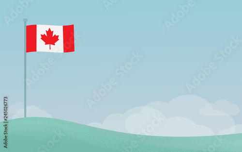 Canadian flag waving on a pole against blue sky background with copyspace