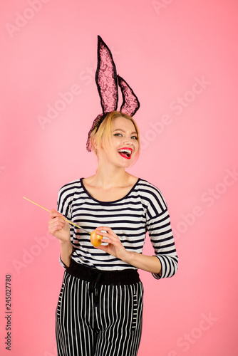 Happy easter! Smiling woman painting egg. Painting eggs for Easter. Sexy Easter bunny girl. Woman holding painting brush. Black rabbit. Egg hunt. Color egg. Sale. Discount. Spring holidays.