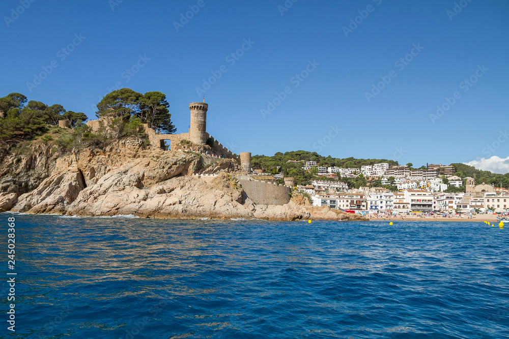 Sea view of the tower of the castle of the medieval village of Tossa de Mar, one of the most picturesque and touristic places of the Catalan Costa Brava