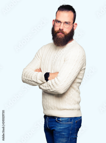 Young hipster man wearing glasses and winter sweater skeptic and nervous, disapproving expression on face with crossed arms. Negative person. © Krakenimages.com