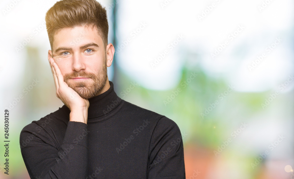 Fototapeta premium Young handsome blond man wearing winter sweater thinking looking tired and bored with depression problems with crossed arms.