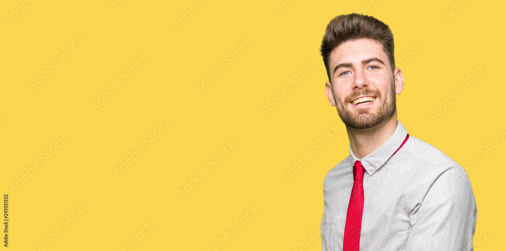Young handsome business man Inviting to enter smiling natural with open hand Young handsome business man Inviting to enter smiling natural with open hand