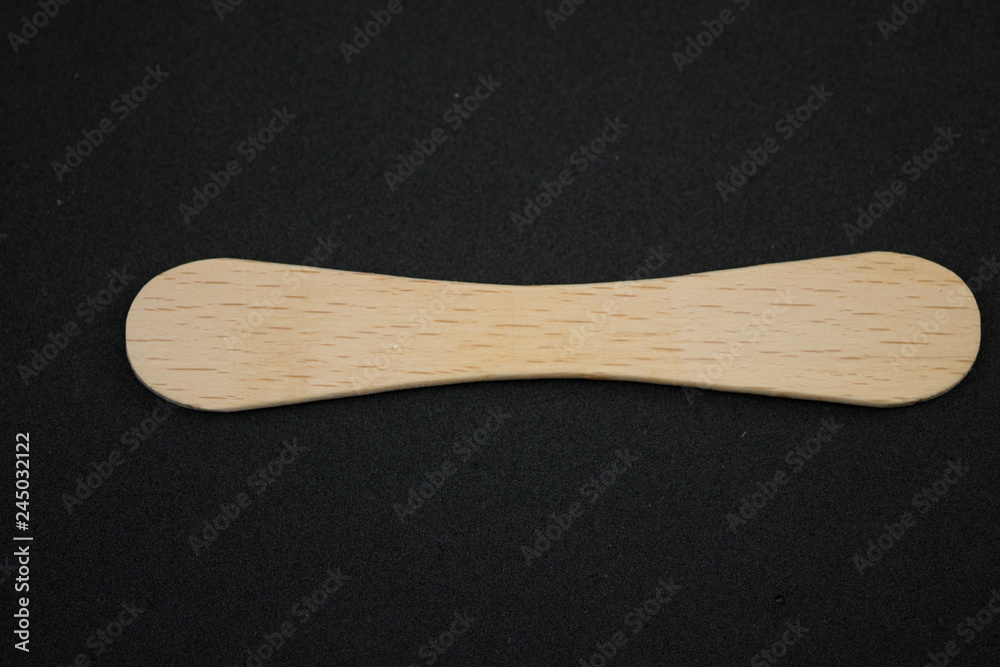 Wooden ice-cream sticks on black background Wooden ice-cream sticks on black background