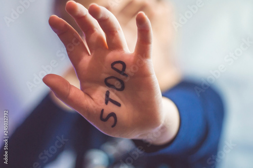 Little frightened girl shows the word 
