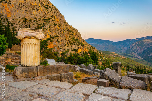 an old column situated at the ancient Delphi site in Greece photo