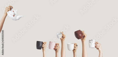 Hands holding different cup on isolated background