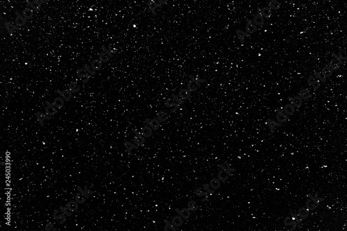 Real snow falling in a winter night. White snow on black background. Abstract elements to use in graphic design or as an overlay for other photos. photo