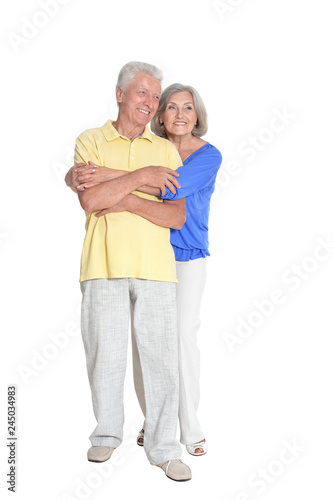 portrait of senior couple embracing on white background