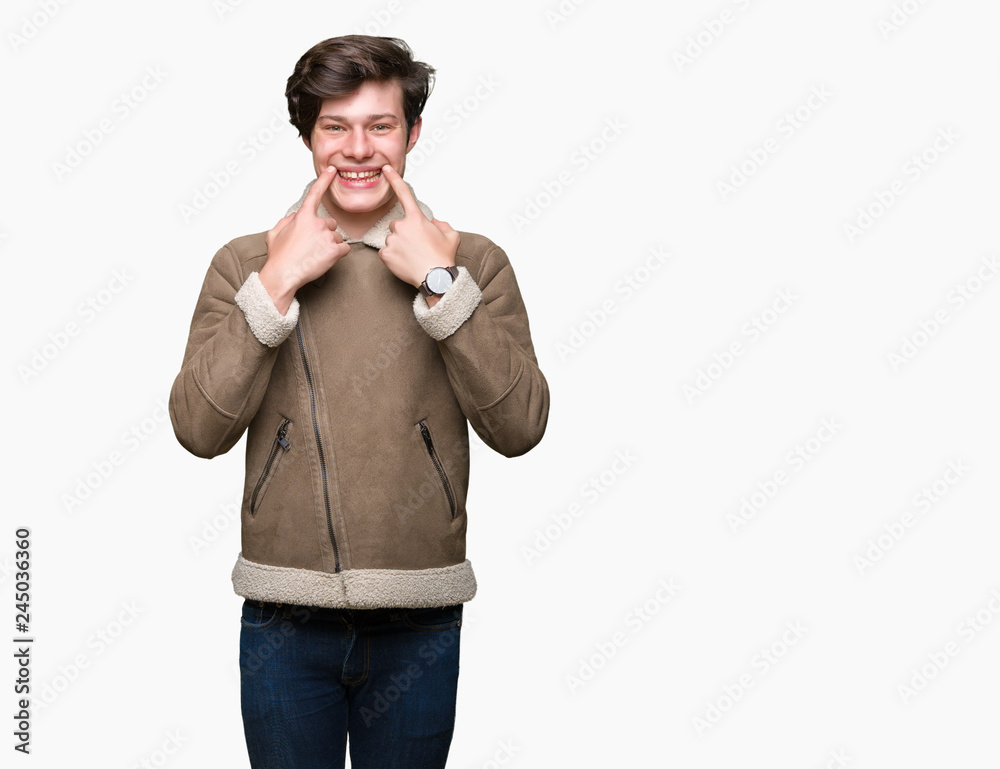 Young handsome man wearing winter coat over isolated background Smiling with open mouth, fingers pointing and forcing cheerful smile Young handsome man wearing winter coat over isolated background Smiling with open mouth, fingers pointing and forcing cheerful smile