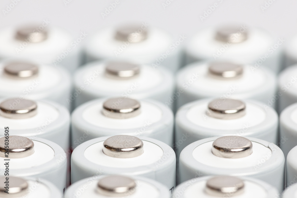 AA batteries are close to each other. Close-up of white batteries on a white background. Battery technology AA batteries are close to each other. Close-up of white batteries on a white background. Battery technology