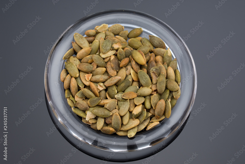 Roasted Pumpkin Seeds on transparent dish Roasted Pumpkin Seeds on transparent dish