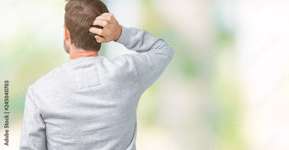 Handsome middle age senior man wearing a sweatshirt over isolated background Backwards thinking about doubt with hand on head Handsome middle age senior man wearing a sweatshirt over isolated background Backwards thinking about doubt with hand on head