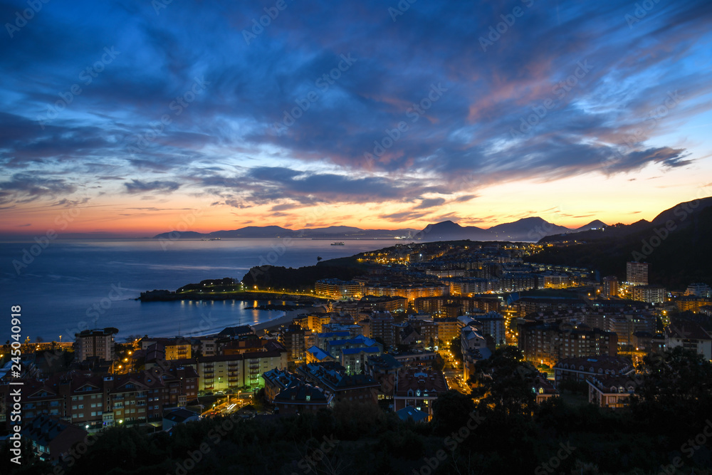 Panoramic view of Castro Urdiales at sunrise with El Abra in the background