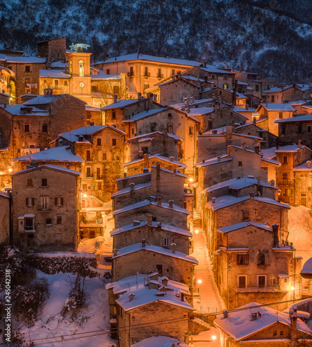 The beautiful Scanno covered in snow during a cold winter evening. Abruzzo, central Italy. photo