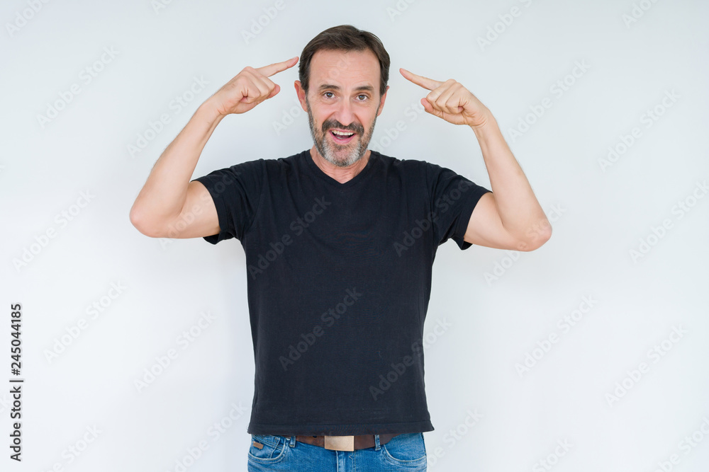 Fototapeta premium Senior man over isolated background Smiling pointing to head with both hands finger, great idea or thought, good memory
