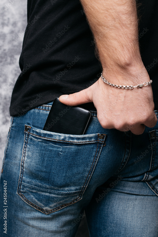 social networks in the pocket of street jeans a man with an elastic ass pulls out