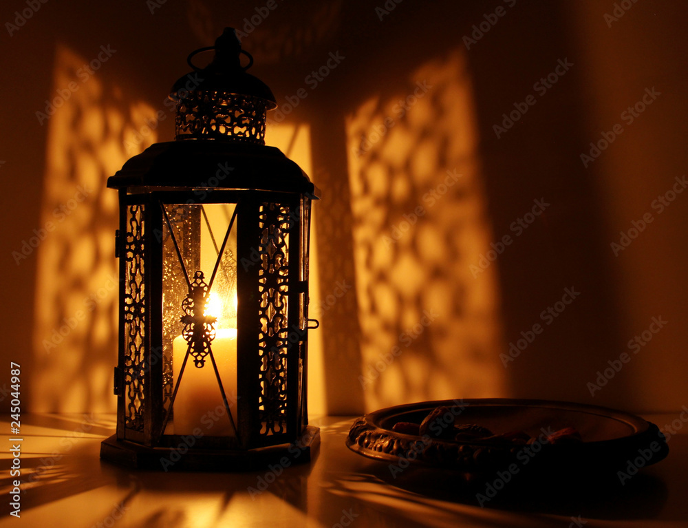 The Muslim feast of the holy month of Ramadan Kareem. Beautiful background with a shining lantern . Free space for your text.