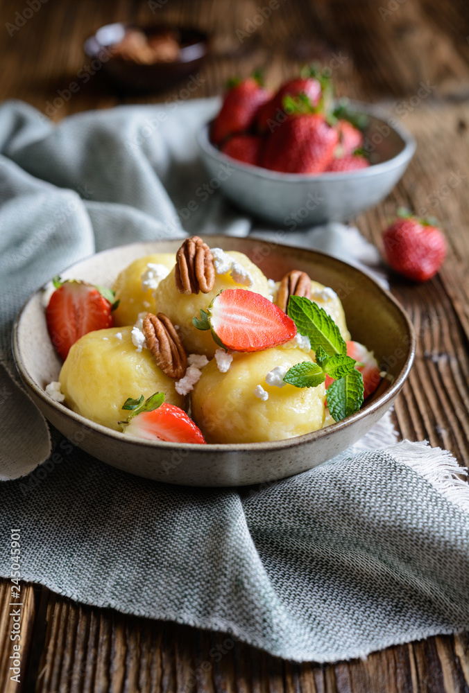 Sweet dumplings stuffed with strawberries topped with curd