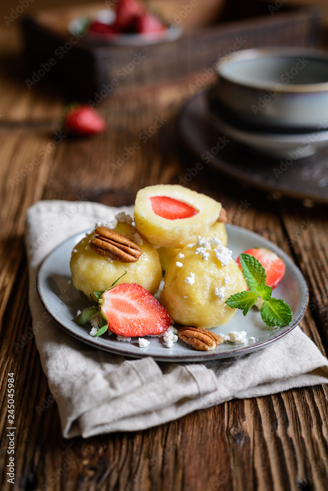 Sweet dumplings stuffed with strawberries topped with curd Sweet dumplings stuffed with strawberries topped with curd
