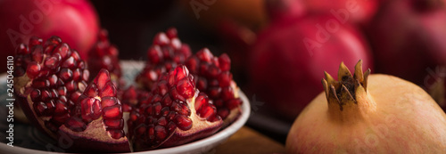 Cuted fresh pomegranate fruits on rustic background. banner maket. selective focus