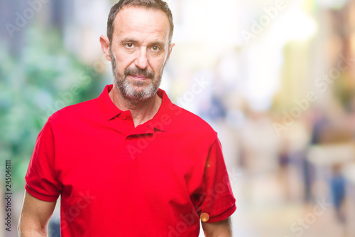 Middle age hoary senior man over isolated background with serious expression on face. Simple and natural looking at the camera.