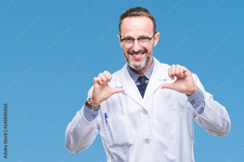 Fototapeta premium Middle age senior hoary professional man wearing white coat over isolated background looking confident with smile on face, pointing oneself with fingers proud and happy.