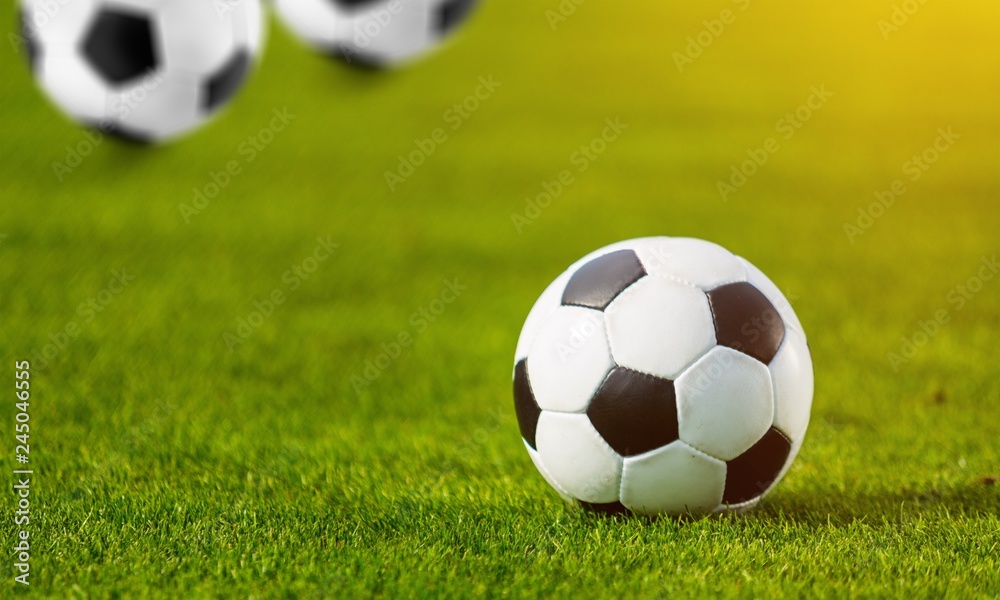 Fototapeta premium Close view of green football field with soccer ball
