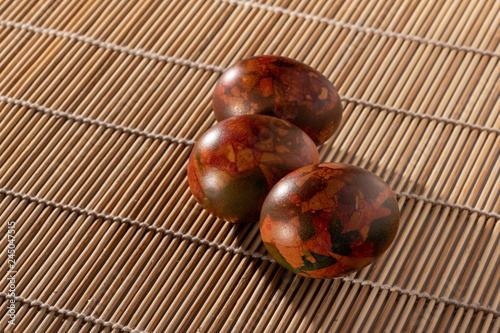 Easter eggs on a wooden tablecloth.