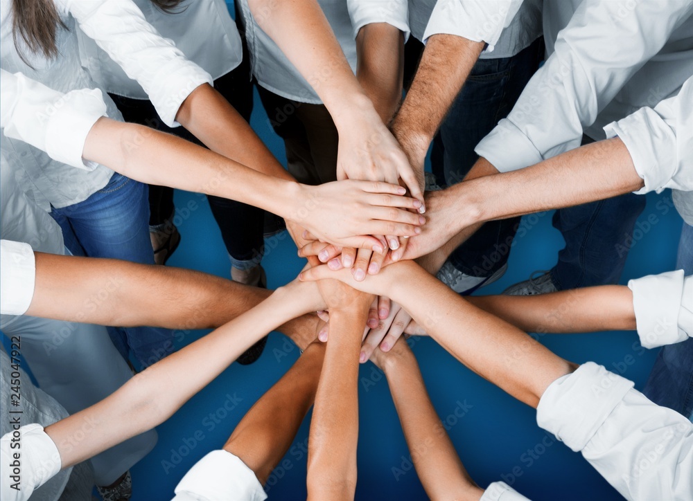 Handshake of many young business people, teamwork concept Handshake of many young business people, teamwork concept