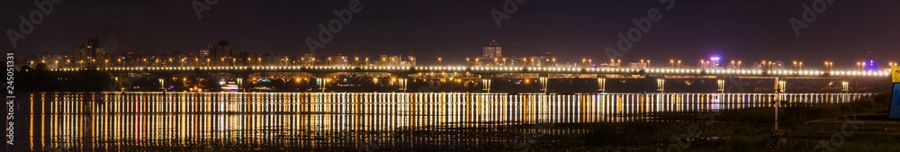 Night panorama of the Paton bridge across the Dnipro in Kyiv