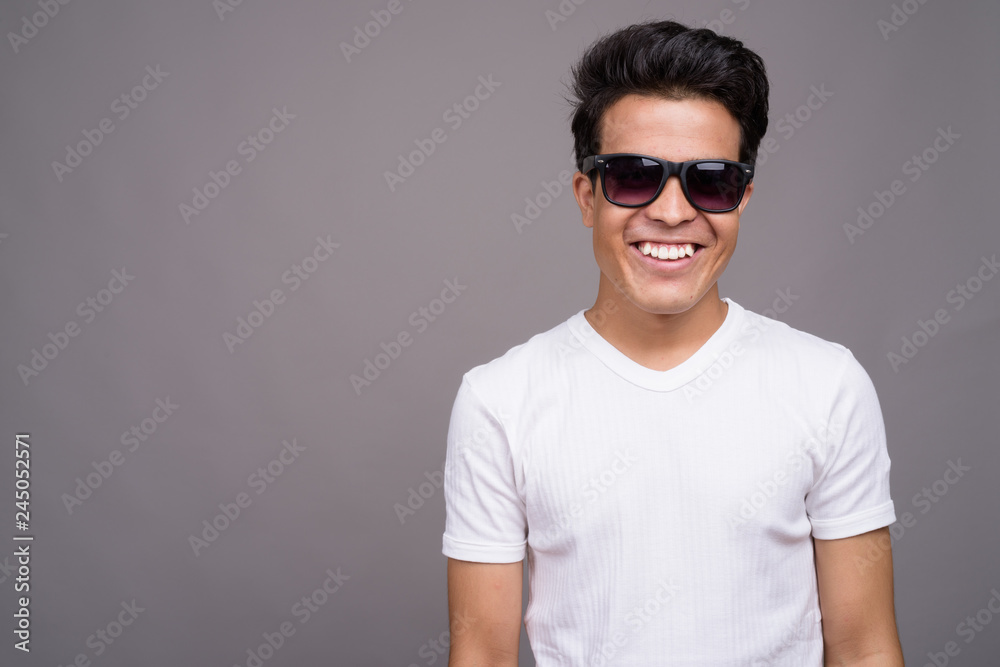 Obraz premium Portrait of young Asian man against gray background