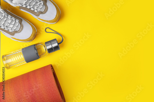 Flat lay composition of sport equipment on color background. Space for text