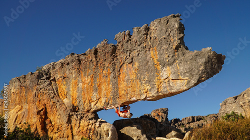 Wallpaper Mural Rock climber on the Rhino boulder in Rocklands near Cape Town, South Africa. Torontodigital.ca