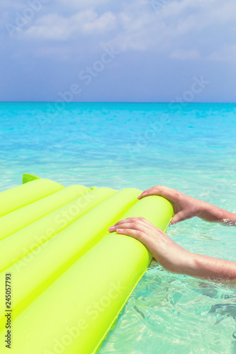 Fototapeta Naklejka Na Ścianę i Meble -  Swimming color green mattress on turquoise sea