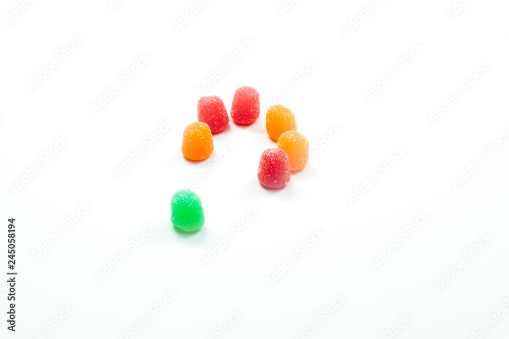 Inclusion - Open ring of gumdrops with one different colored gumdrop outside the circle Inclusion - Open ring of gumdrops with one different colored gumdrop outside the circle