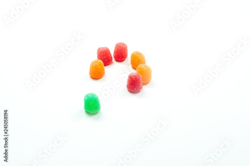 Konstfotografi Inclusion - Open ring of gumdrops with one different colored gumdrop outside the