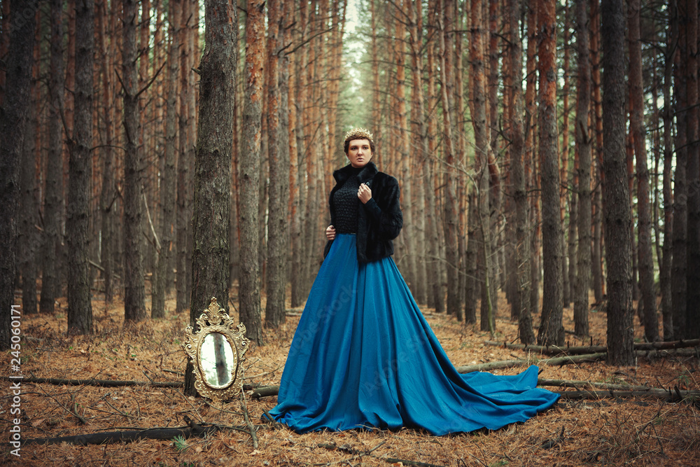 Model wearing blue skirt is posing as a queen Model wearing blue skirt is posing as a queen