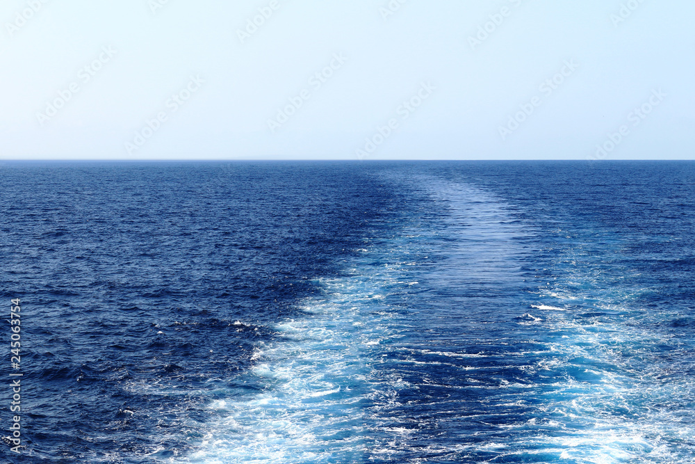 A wake of a ship cruising the Pacific Ocean