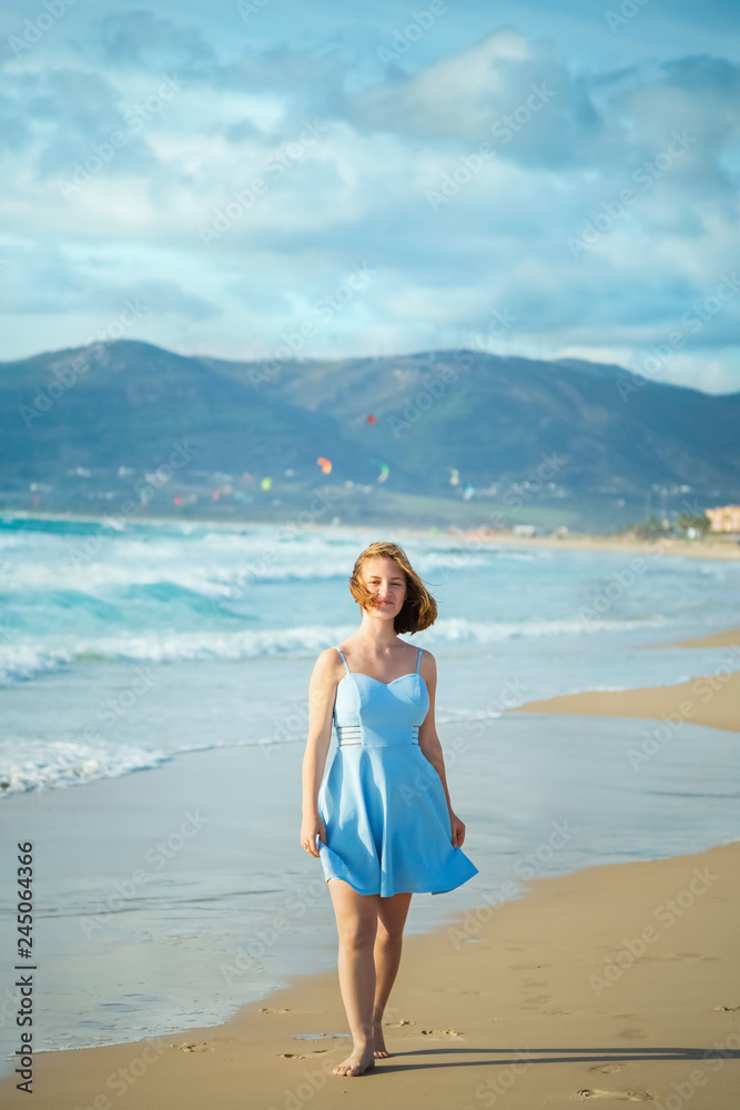 Girl walking on sandy beach