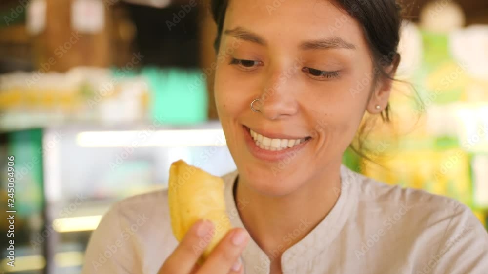 Young Tourist Woman Trying Durian First Time. Female Holding Piece of Durian Pulp and Sniffing It Enjoying Good Sweet Smell. 4K Slowmotion. Kuala Lumpur, Malaysia. Young Tourist Woman Trying Durian First Time. Female Holding Piece of Durian Pulp and Sniffing It Enjoying Good Sweet Smell. 4K Slowmotion. Kuala Lumpur, Malaysia.