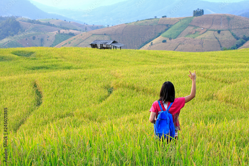 beautiful young woman on in rice terraces fieldswith mountain view and smiling at Doi Inthanon Chiang Mai Thailand