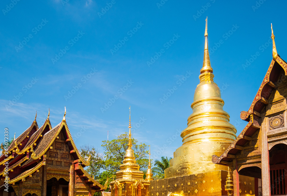 Naklejka premium Wat Phra Singh landmark in Chiang Mai is a Lanna style temple. It is the main temple of Chiang Mai and is a popular tourist attraction for tourists visiting in travel concept.