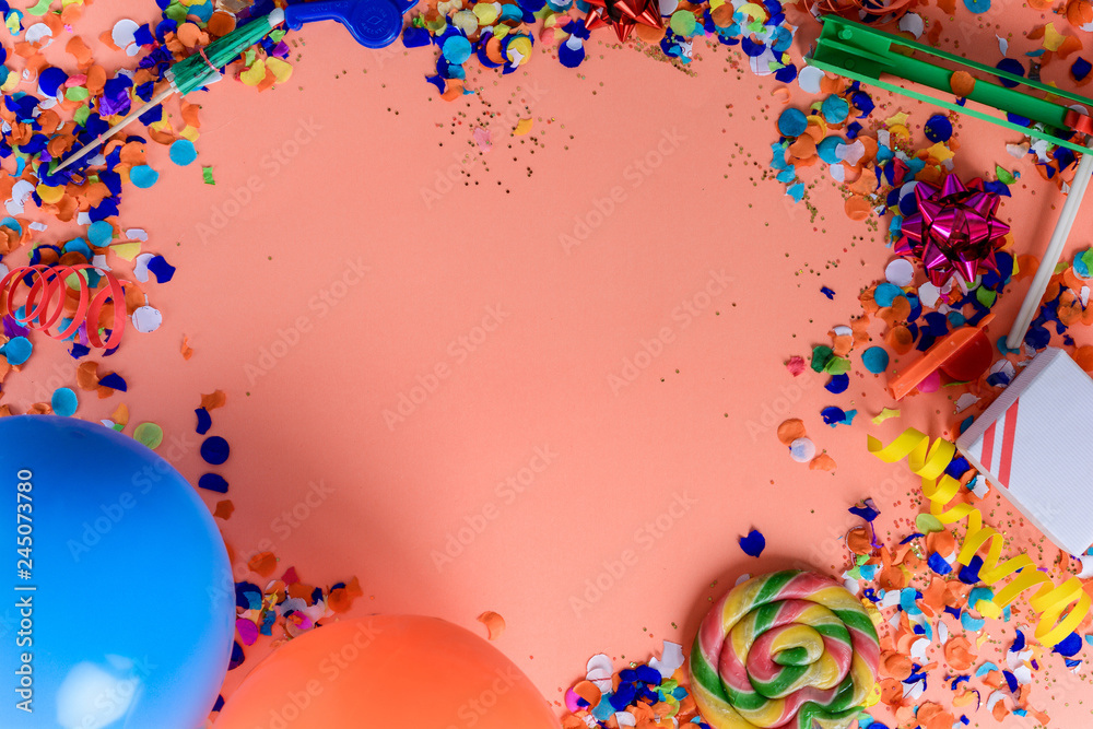Top view of birthday party objects on colorful background