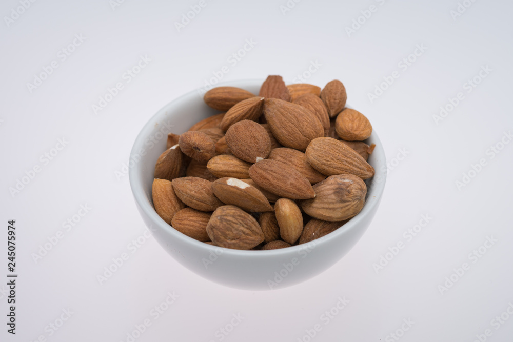 Dried almons in porcelain bowl Dried almons in porcelain bowl