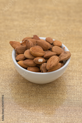 Dried almons in porcelain bowl photo