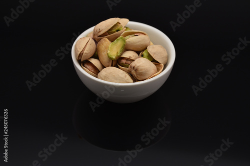 Roasted pistachio seeds with shell in bowl