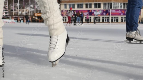 women learn ice skating outdoor at ice rink